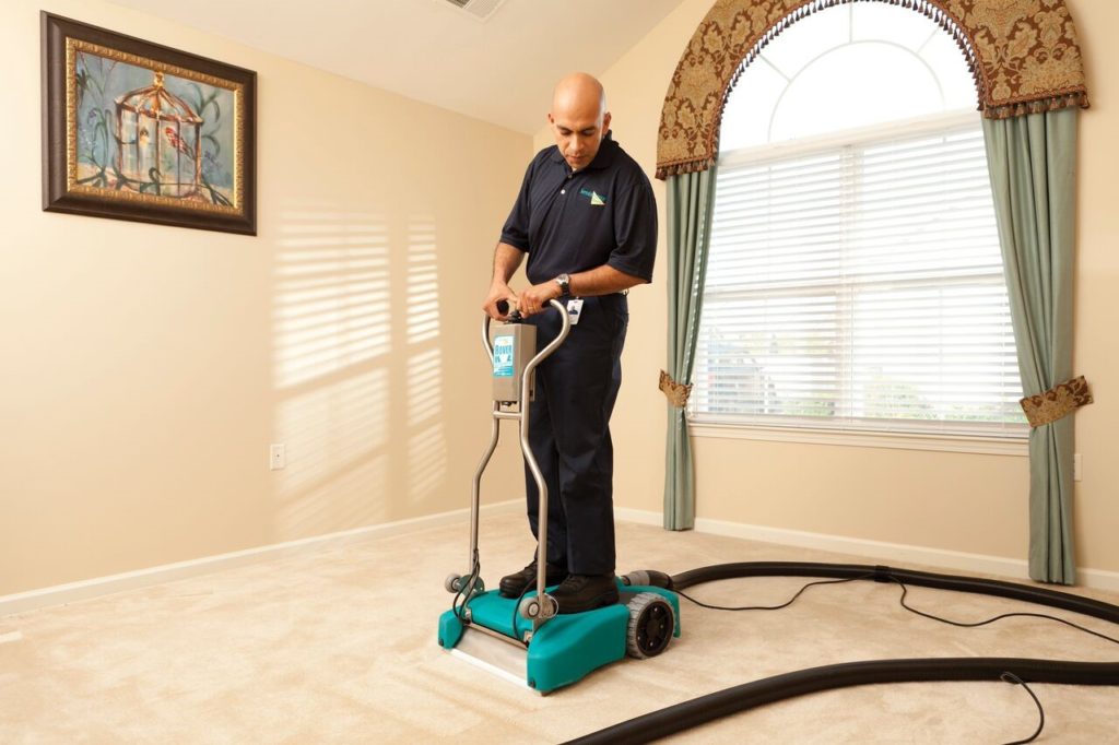 technician using carpet cleaning machine