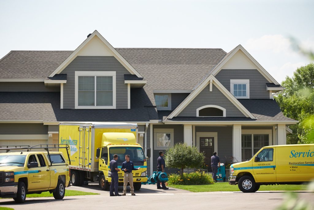 servicemaster vehicles in front of home